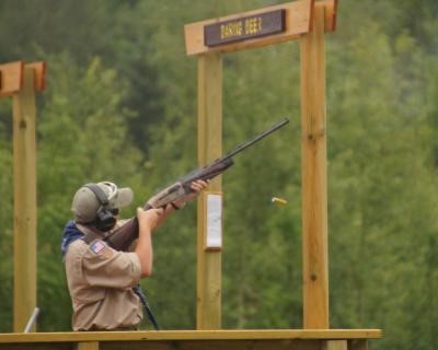 A Scout aiming a shotgun downrange