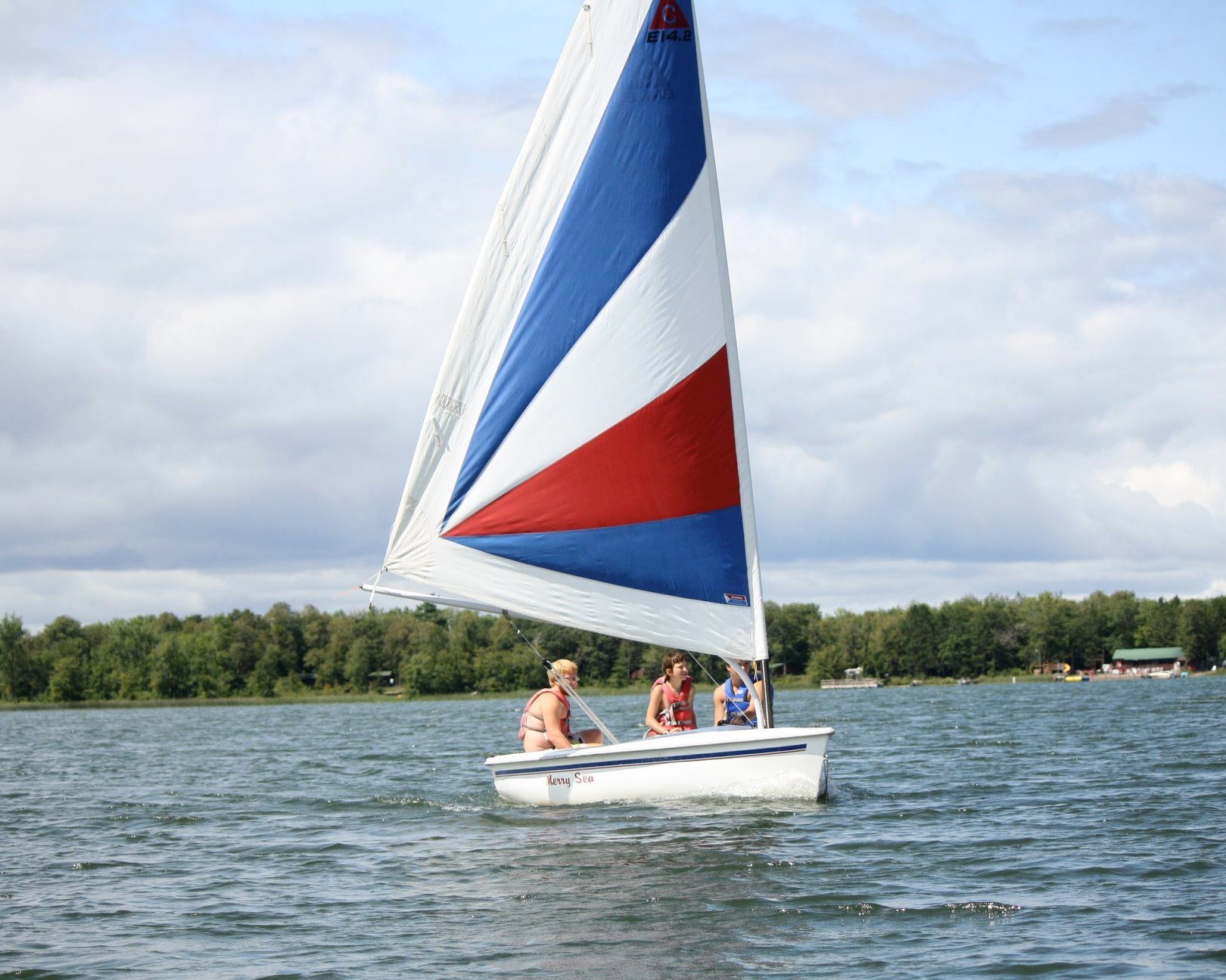 Three Scouts on a large sailboat on the lake
